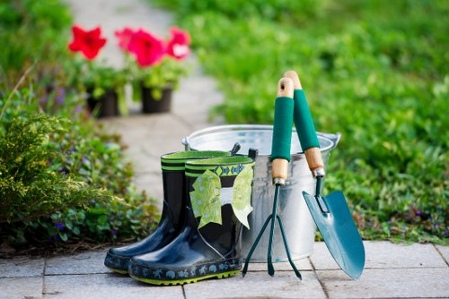 Gardener mowing a compact front lawn in Mayfair